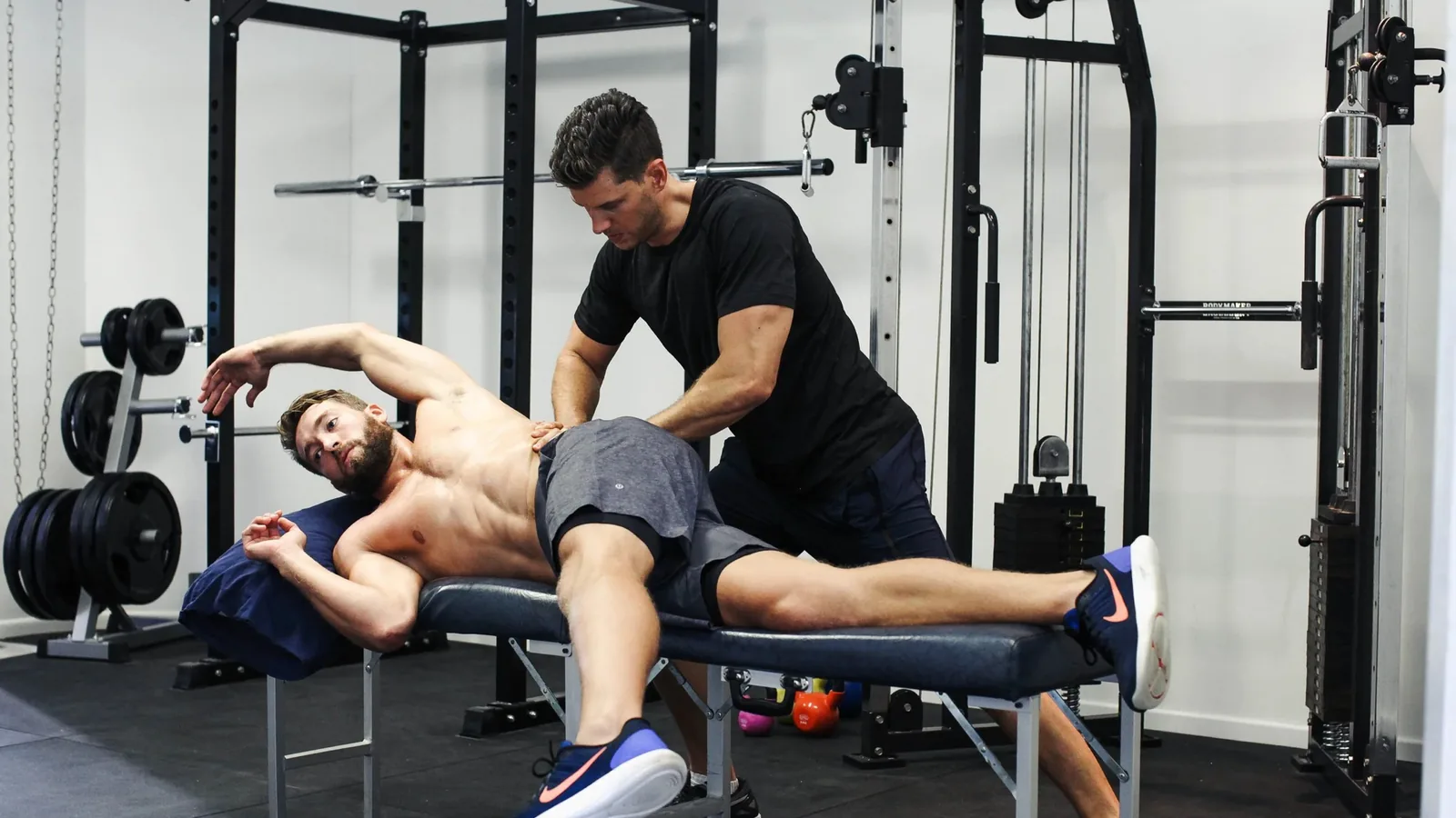 A physiotherapist treating a patient in a clinic gym